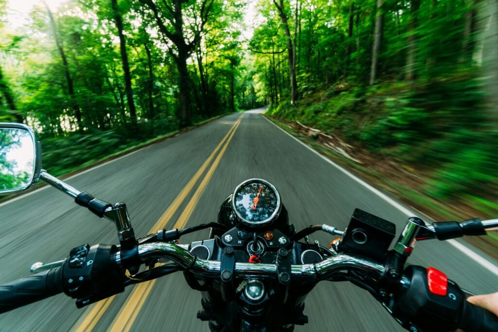 Experience the thrill of a motorcycle ride through a scenic, winding forest road. Feel the speed and freedom.
